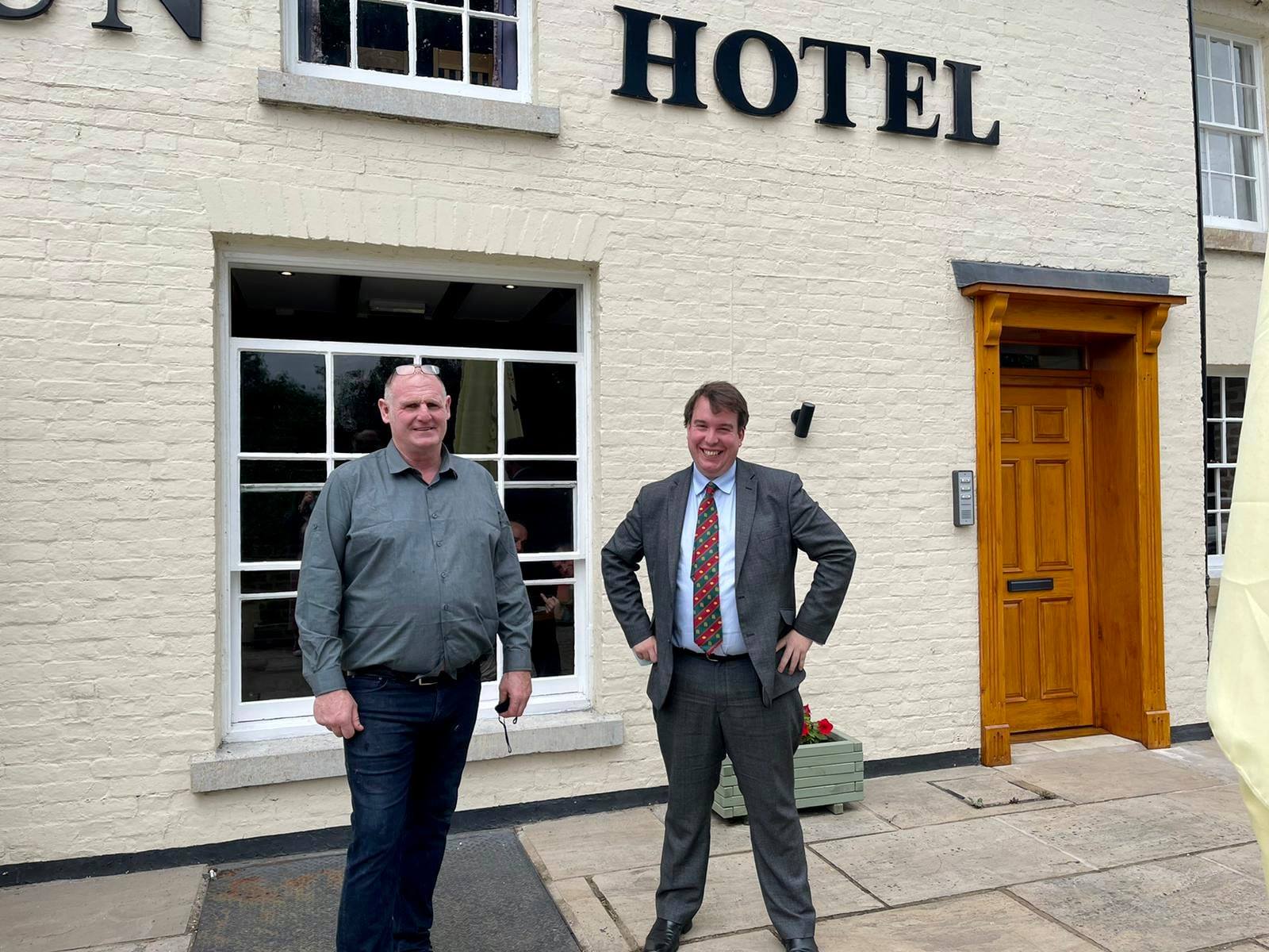 Craig with Gwynfor Thomas, County Councillor for Llansantffraid, outside of the newly reopened Sun Hotel in Llansantffraid.